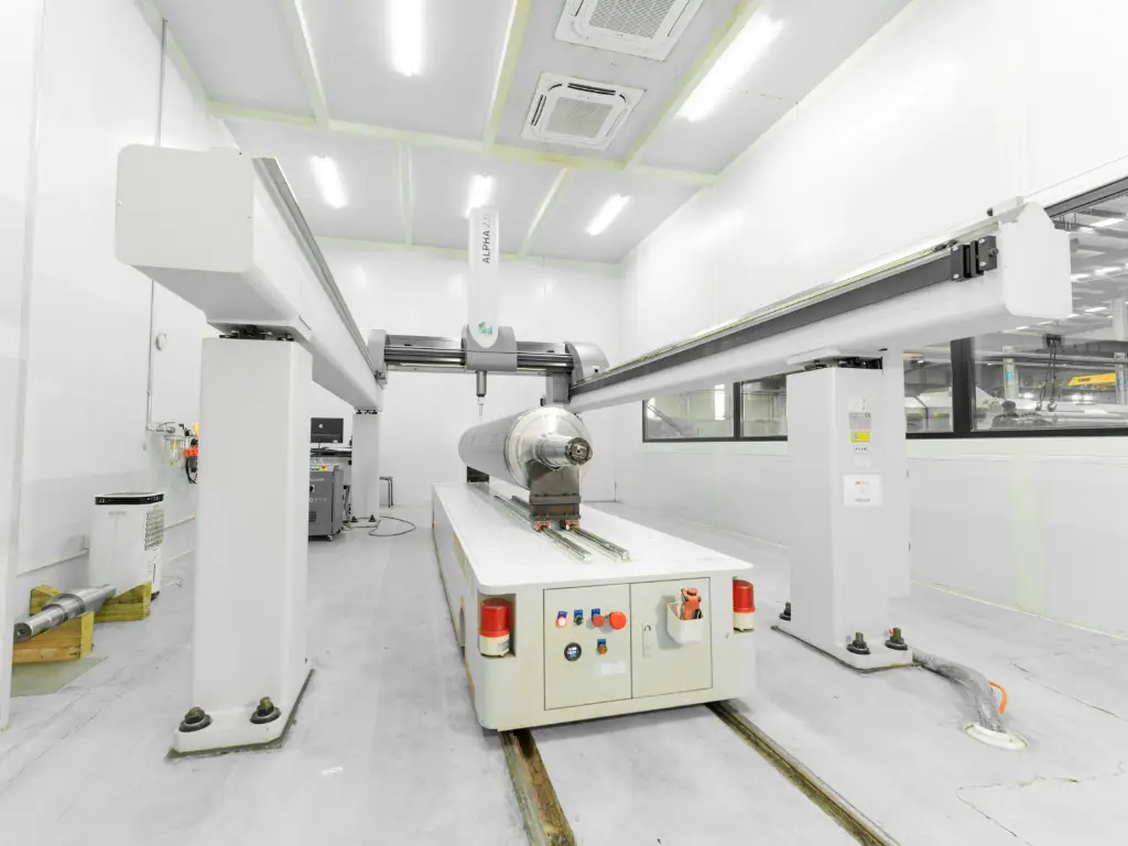 Interior view of RMM's quality control workshop, featuring a large coordinate measuring machine (CMM) and other inspection equipment.