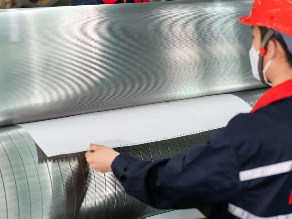 Detailed view of the precise engagement of upper and lower corrugated rolls during operation.