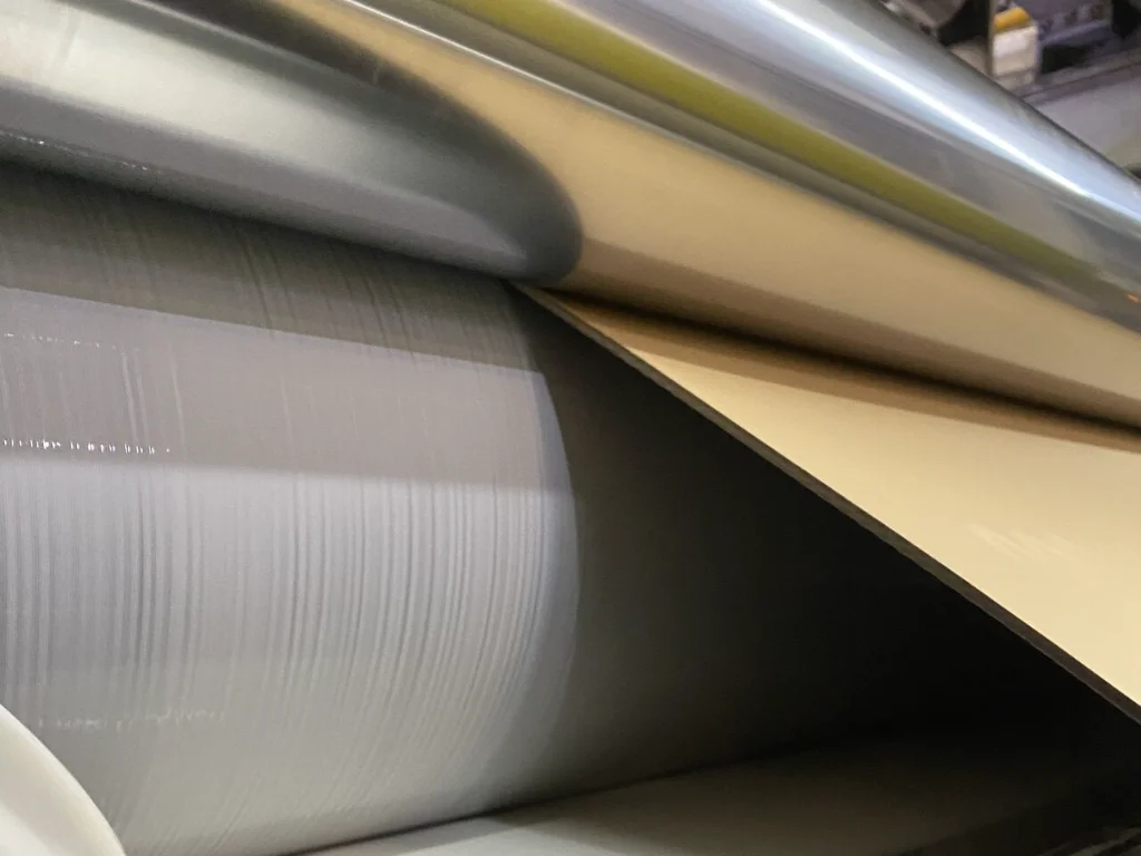 Corrugating rolls operating in a single facer machine during corrugated board production, ensuring precise flute formation and stable paper bonding.