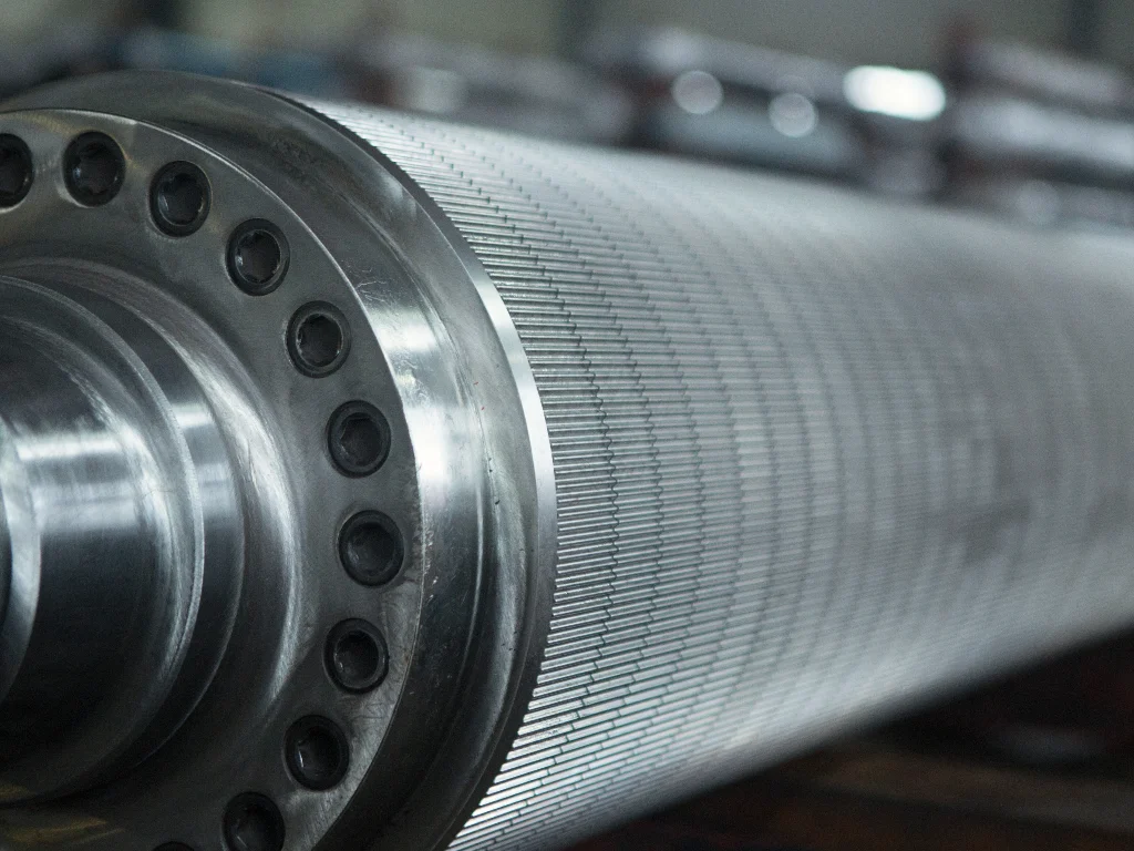 Close-up view of a corrugating roll showing precise flute profile and machined surface details.