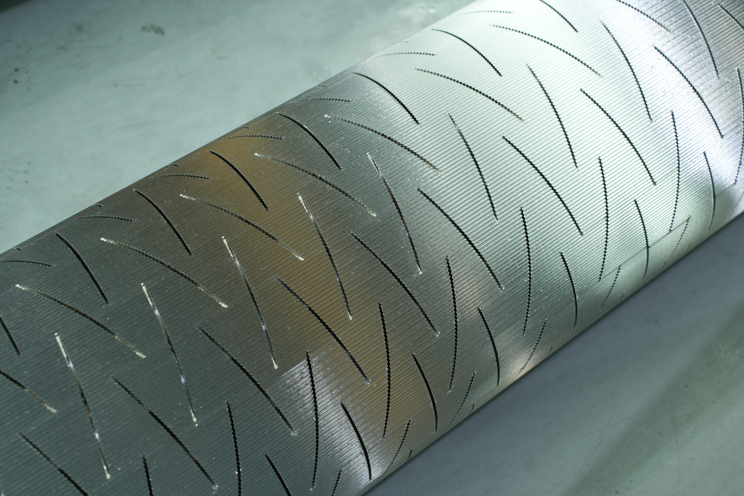 A close-up shot of an E-flute tungsten carbide corrugating roll