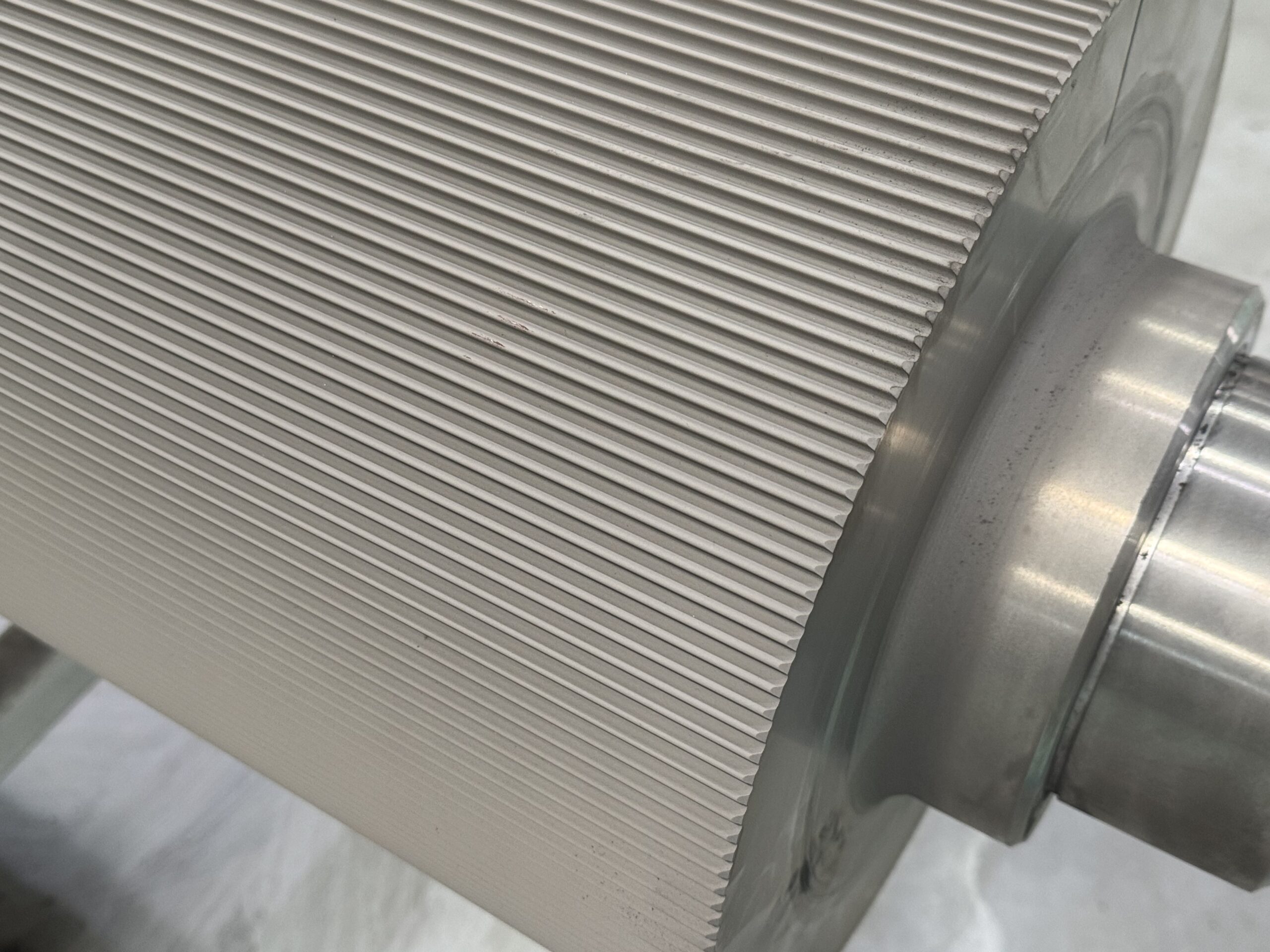 A close-up of a tungsten carbide corrugating roll's surface