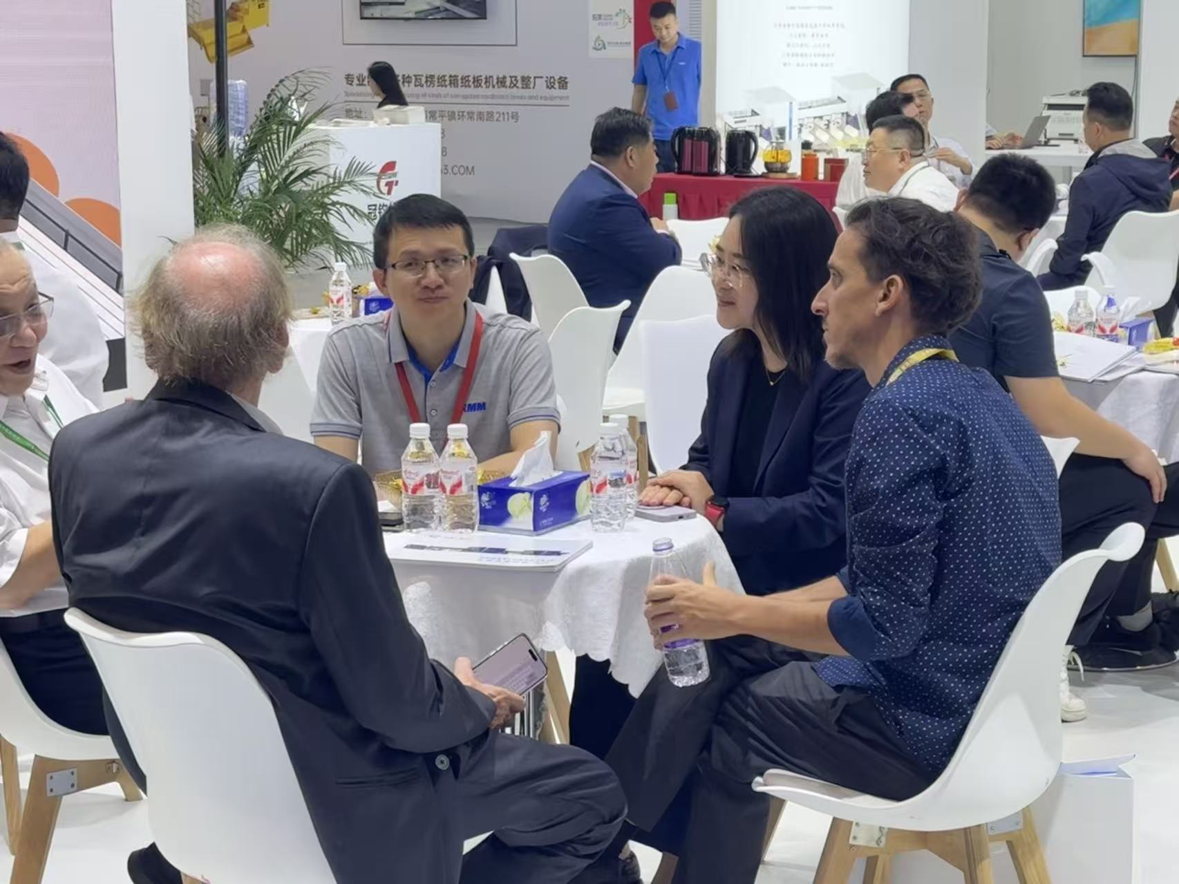 A busy RMM booth at WEPACK 2026 with customers talking to staff