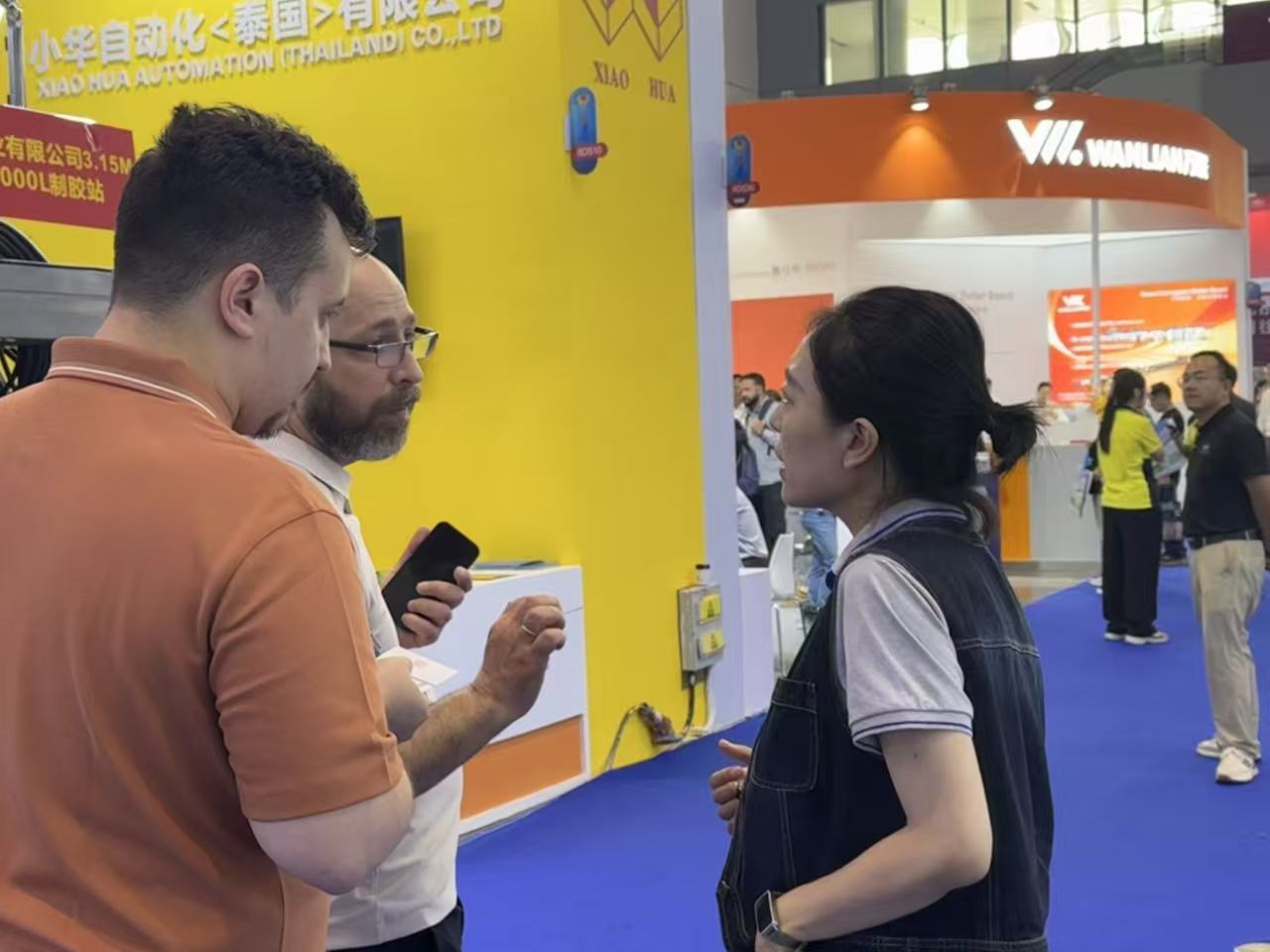 A busy RMM booth at WEPACK 2026 with customers talking to staff